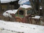 Rusty Old Truck Covered in Snow